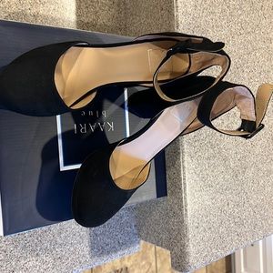 Gently used black suede platform heels,